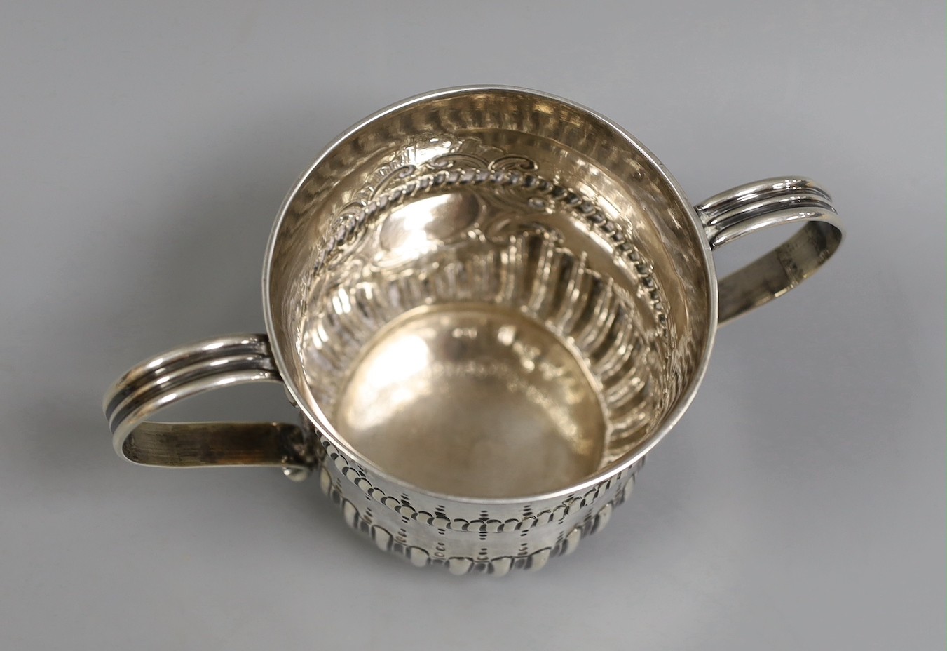 An early George III demi-fluted silver porringer, by John Moore, London, 1761, height 85mm, 7.2oz, with contemporary engraved date.